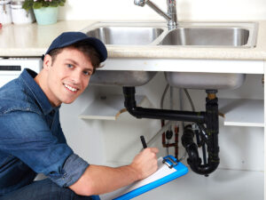 %Focuskw% | Divine Image of a plumber cutting copper pipe