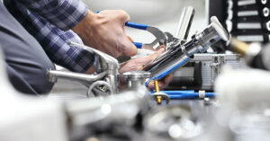 Closeup of plumber using tools to fix a plumbing issue