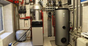 A room with a water heater and extensive piping