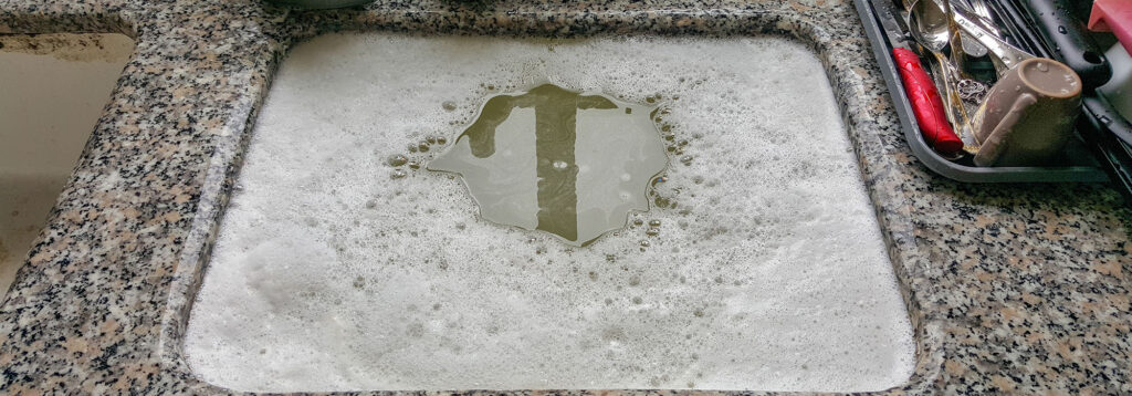 Clogged sink with water