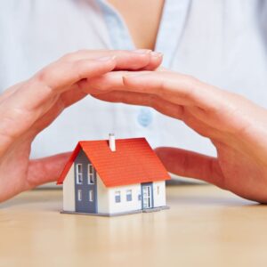 hands over a toy home
