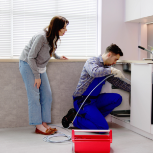 %Title% | Divine Plumber trying to remove a clog from a sink pipe.
