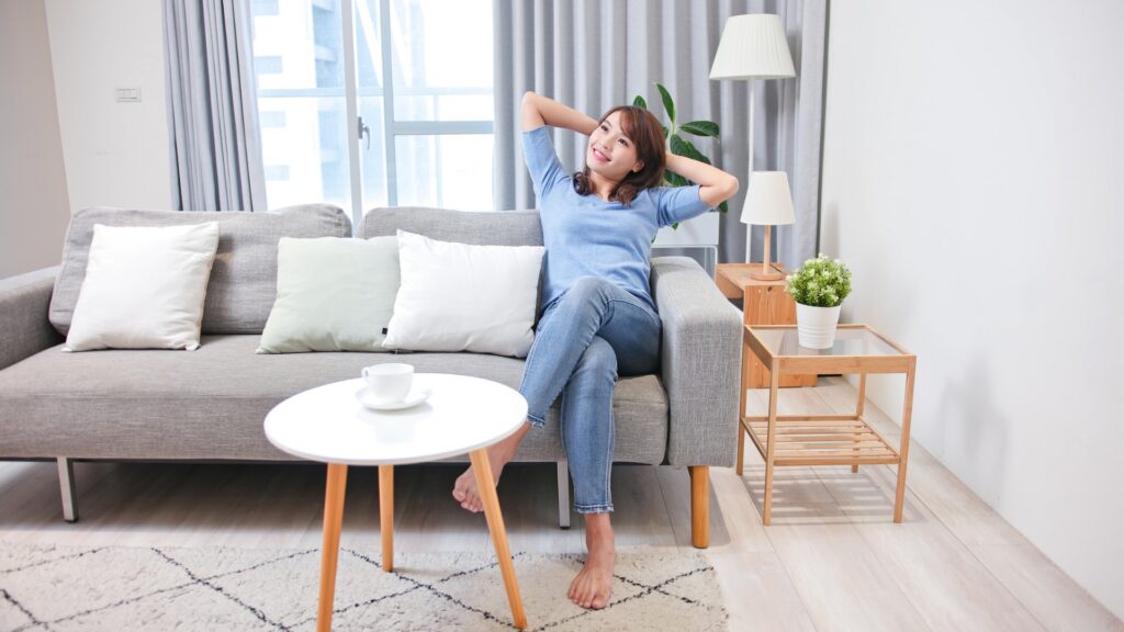 Woman happily relaxing on a couch
